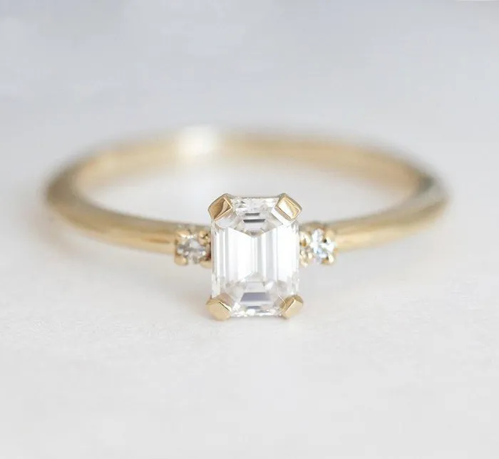 Capucinne Rings Sleek Simple EmeraldCut Diamond Ring With Side Diamonds