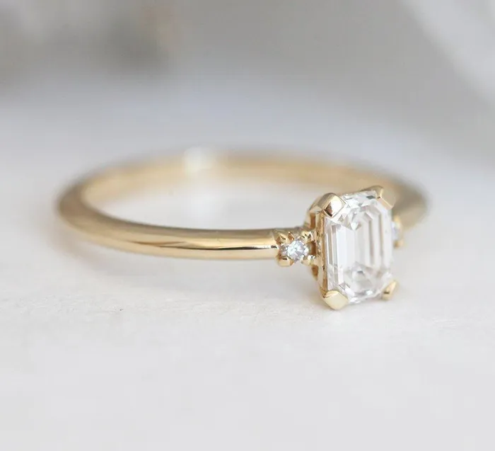 Capucinne Rings Sleek Simple EmeraldCut Diamond Ring With Side Diamonds