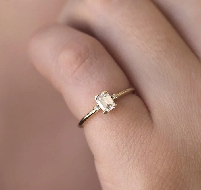 Capucinne Rings Sleek Simple EmeraldCut Diamond Ring With Side Diamonds