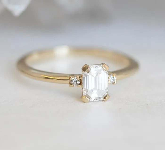 Capucinne Rings Sleek Simple EmeraldCut Diamond Ring With Side Diamonds