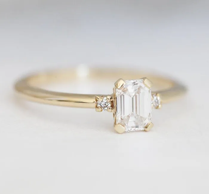 Capucinne Rings Sleek Simple EmeraldCut Diamond Ring With Side Diamonds