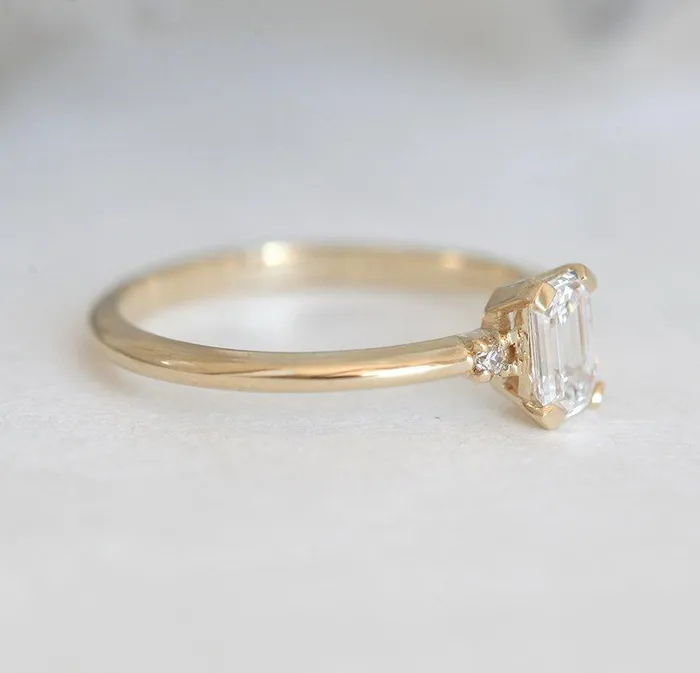 Capucinne Rings Sleek Simple EmeraldCut Diamond Ring With Side Diamonds