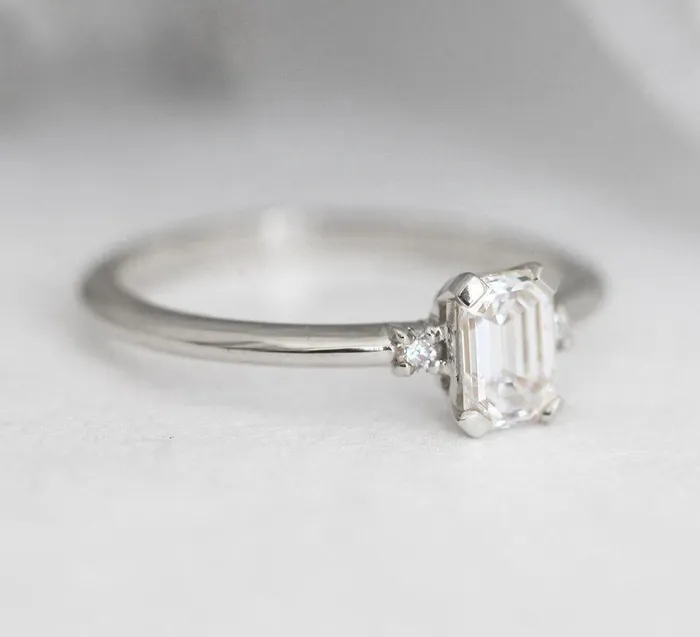 Capucinne Rings Sleek Simple EmeraldCut Diamond Ring With Side Diamonds